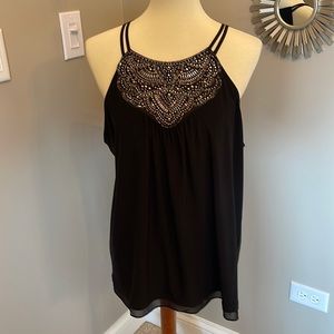 Sleeveless blouse with rhinestones.